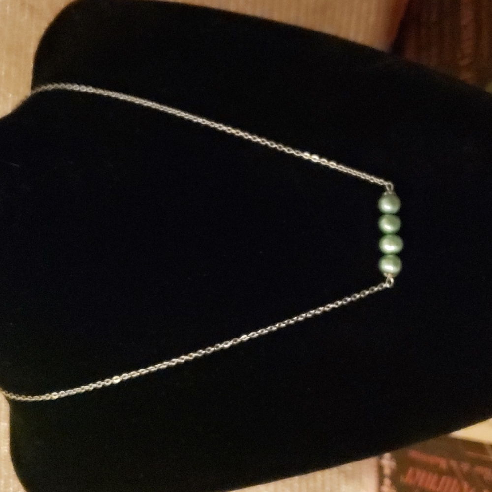 Nwt...9.25 Silver necklace w/ four blue balls hanging from end of chain.